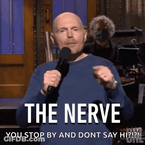 A Man Is Holding A Microphone And Says The Nerve GIF