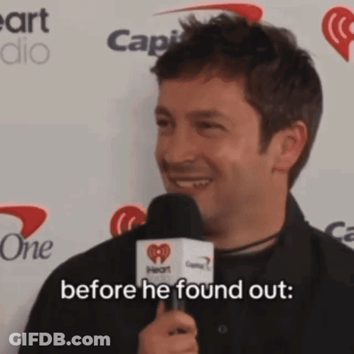 A Man Is Holding A Microphone And Smiling While Saying Before He Found Out GIF