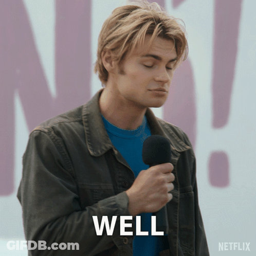 A Man Is Holding A Microphone And The Word Well Is On The Screen GIF