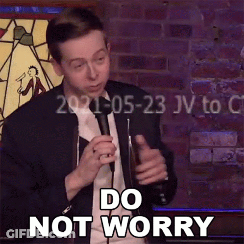 A Man Is Holding A Microphone In Front Of A Brick Wall And Says Do Not Worry GIF