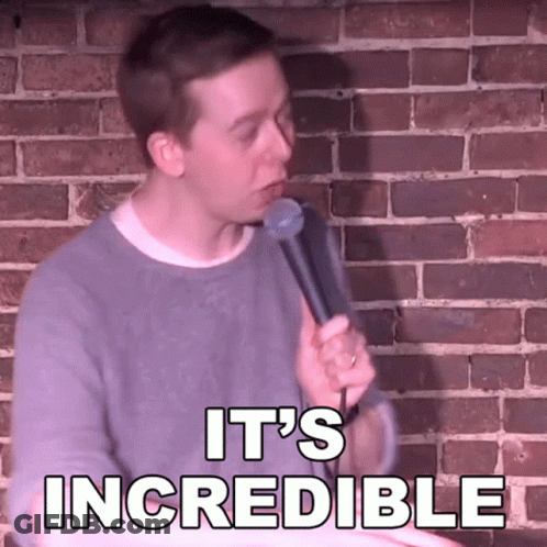 A Man Is Holding A Microphone In Front Of A Brick Wall And Says " It 'S Incredible " GIF