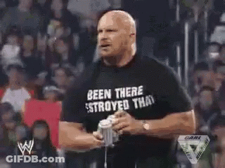 A Man Is Holding A Microphone In Front Of A Crowd With A W Logo On The Bottom Right Corner GIF