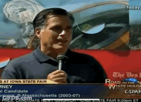 A Man Is Holding A Microphone In Front Of A Sign That Says " The Road To The White House " GIF