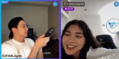A Man Is Holding A Microphone In Front Of A Woman Who Is Smiling In A Video Chat GIF