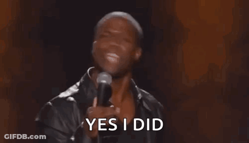 A Man Is Holding A Microphone In His Hand And Saying Yes I Did . GIF