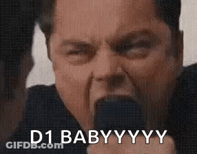 A Man Is Holding A Microphone In His Mouth And Saying `` D1 Baby Yyy '' . GIF