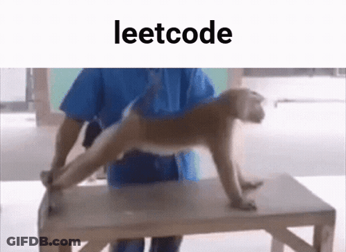 A Man Is Holding A Monkey On A Wooden Table . GIF