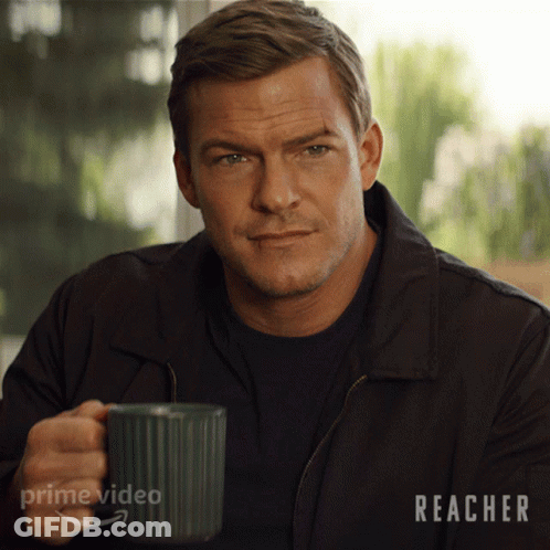 A Man Is Holding A Mug With The Word Prime Video On It GIF