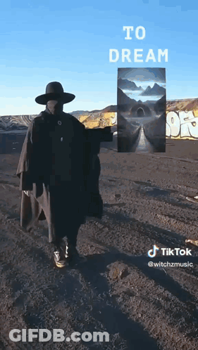 Man Holding Painting In Front Of Dream Sign GIF