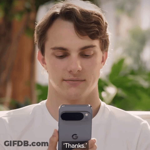 A Man Is Holding A Phone That Says ' Thanks ' On The Screen GIF