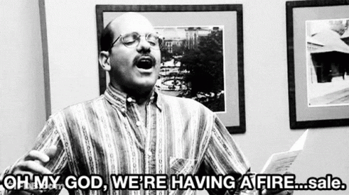A Man Is Holding A Piece Of Paper And Saying Oh My God We 'Re Having A Fire Sale .. GIF