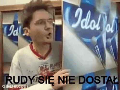 A Man Is Holding A Piece Of Paper That Says Idol On It GIF