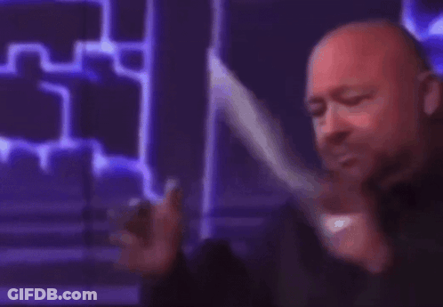 A Man Is Holding A Piece Of Paper That Says Liberal On It GIF