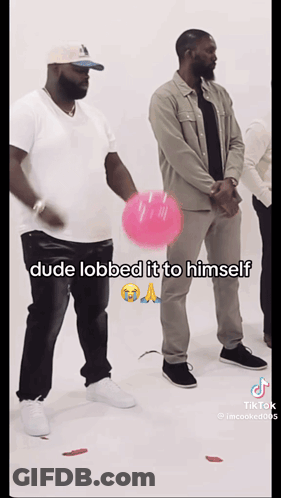 A Man Is Holding A Pink Balloon And Says Dude Lobbed It To Himself On The Bottom GIF