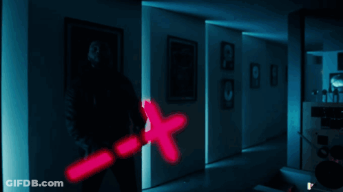 A Man Is Holding A Pink X Shaped Object GIF