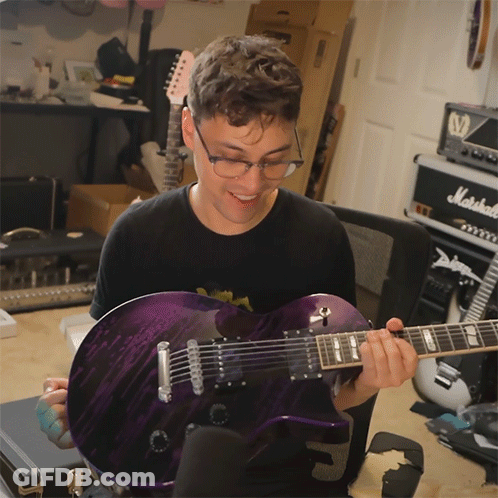 Man Holding Purple Guitar In Front Of Marshall Amp GIF