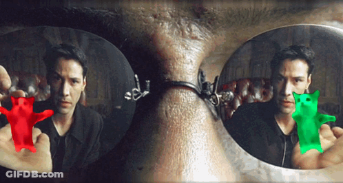 A Man Is Holding A Red Gummy Bear And A Green Gummy Bear In Front Of His Face GIF