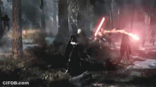 A Man Is Holding A Red Light Saber In A Forest GIF