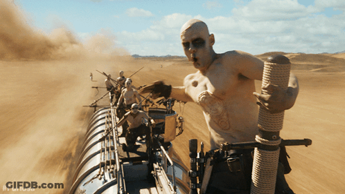 A Man Is Holding A Rope In The Desert With #Furiosa On The Bottom Right GIF