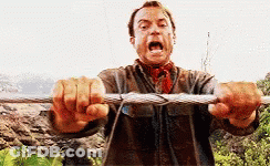 A Man Is Holding A Rope With His Mouth Open And Screaming . GIF