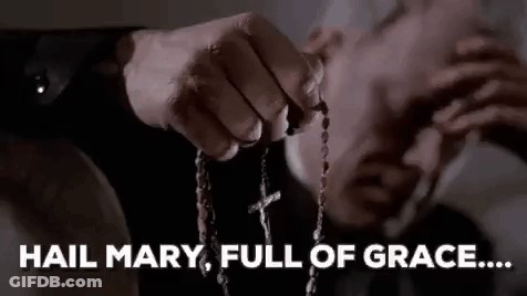 A Man Is Holding A Rosary In His Hand And Says `` Hail Mary , Full Of Grace ... '' . GIF