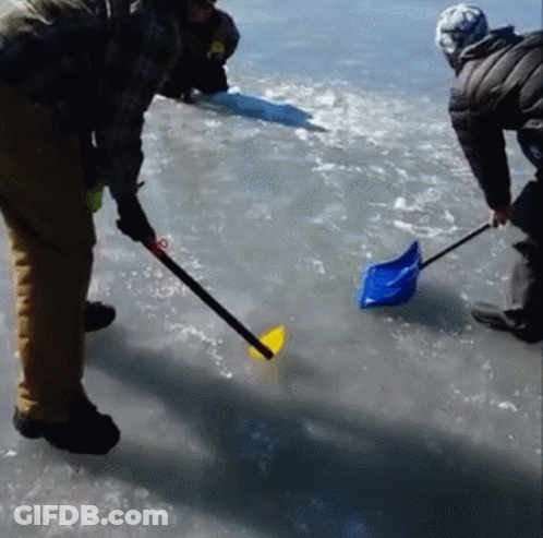 A Man Is Holding A Shovel In The Water GIF