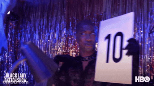 A Man Is Holding A Sign That Says 10 On It GIF