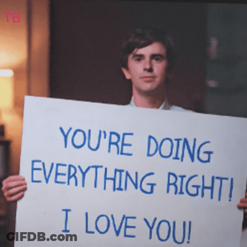 A Man Is Holding A Sign That Says " You 'Re Doing Everything Right I Love You " GIF