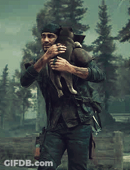 A Man Is Holding A Small Dog In His Arms . GIF