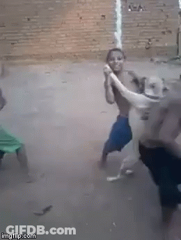 A Man Is Holding A Snake In His Hands While Another Man Holds A Rope . GIF