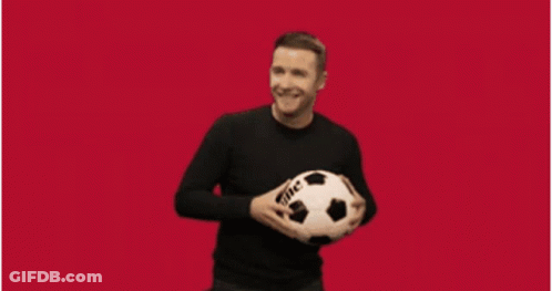 A Man Is Holding A Soccer Ball In Front Of A Sports Logo GIF