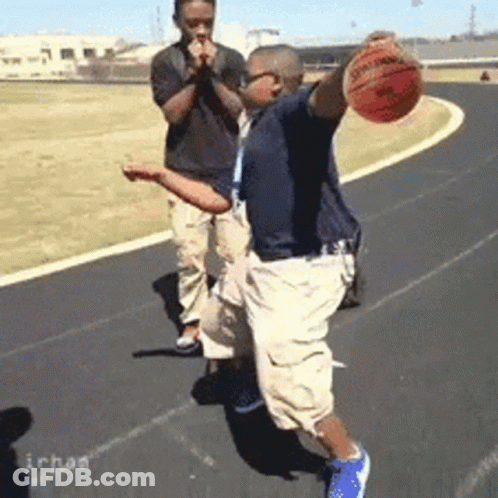 A Man Is Holding A Spalding Basketball In His Hands GIF