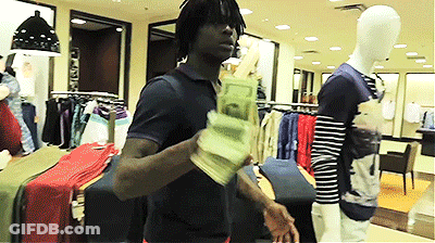 A Man Is Holding A Stack Of Money In A Store GIF