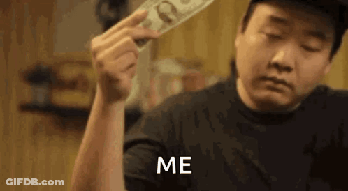 A Man Is Holding A Stack Of Money In His Hand And Says `` Me '' . GIF