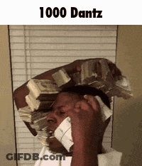 A Man Is Holding A Stack Of Money On His Head While Talking On A Cell Phone . GIF