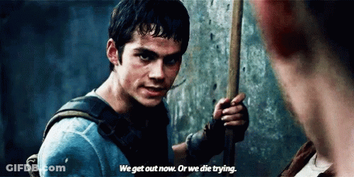 A Man Is Holding A Stick In His Hand And Talking To Another Man . GIF