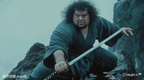 A Man Is Holding A Sword In Front Of A Kingal 2.1 Logo GIF