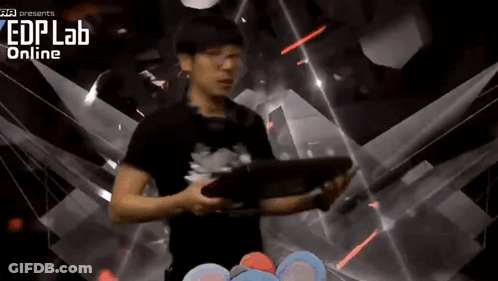 A Man Is Holding A Tablet In Front Of A Screen That Says Edplab Online GIF