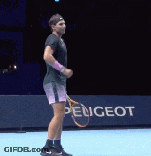 A Man Is Holding A Tennis Racket In Front Of A Peugeot Sign GIF