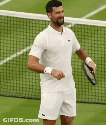 A Man Is Holding A Tennis Racket On A Tennis Court . GIF