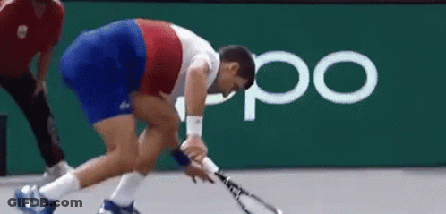 A Man Is Holding A Tennis Racquet On A Court In Front Of An Oppo Logo . GIF