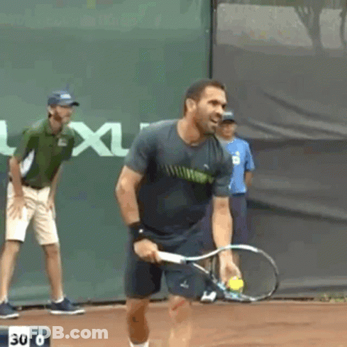 A Man Is Holding A Tennis Racquet On A Court With The Number 30 On The Bottom GIF