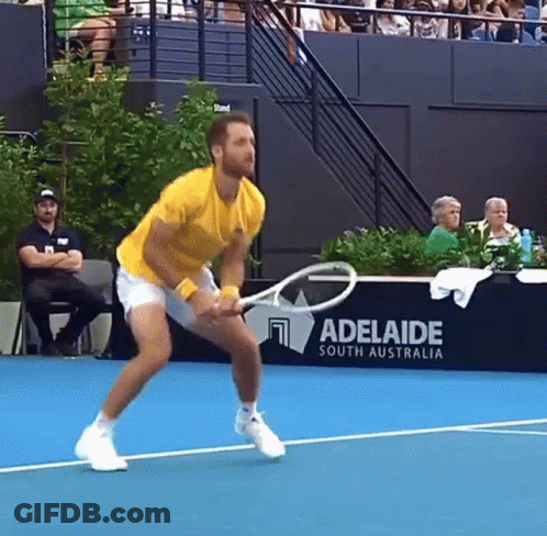A Man Is Holding A Tennis Racquet On A Tennis Court In Front Of A Adelaide South Australia Sign GIF