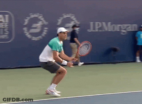 A Man Is Holding A Tennis Racquet On A Tennis Court In Front Of A J.p. Morgan Sign GIF