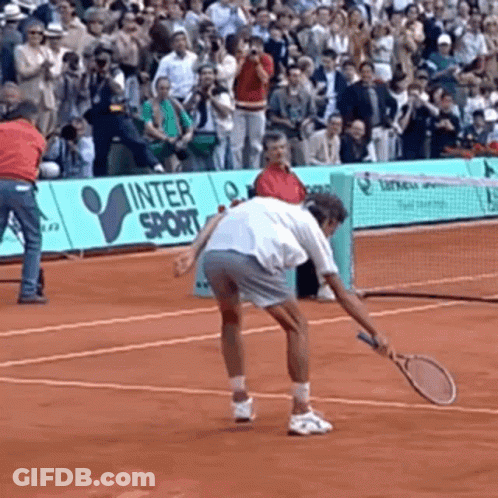 A Man Is Holding A Tennis Racquet On A Tennis Court In Front Of A Sign That Says Inter Sport GIF