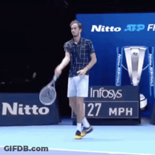 A Man Is Holding A Tennis Racquet On A Tennis Court In Front Of A Sign That Says Nitto GIF