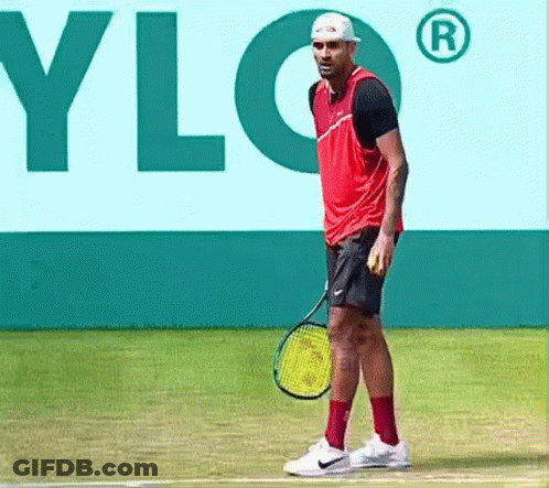 A Man Is Holding A Tennis Racquet On A Tennis Court In Front Of A Sign That Says Ylg GIF