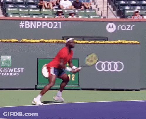 A Man Is Holding A Tennis Racquet On A Tennis Court With A Motorola Logo In The Background GIF