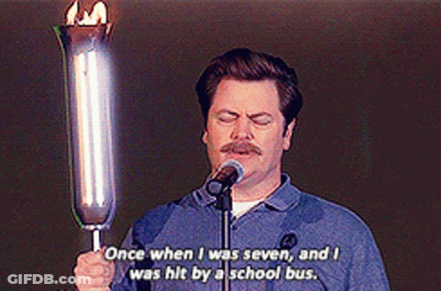 A Man Is Holding A Torch In Front Of A Microphone And Says Once When I Was Seven GIF