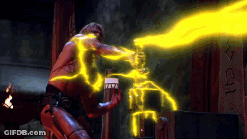 A Man Is Holding A Torch With A Flame Coming Out Of It And The Letters I And J Are On The Wall GIF
